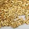 Close up view of a pile of 2mm Gold Crimp Tubes for Jewelry Making