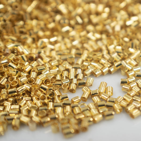Close up view of a pile of 2mm Gold Crimp Tubes for Jewelry Making