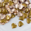 Top view of a pile of Gold Glitter Enamel Heart Charm 15mm
