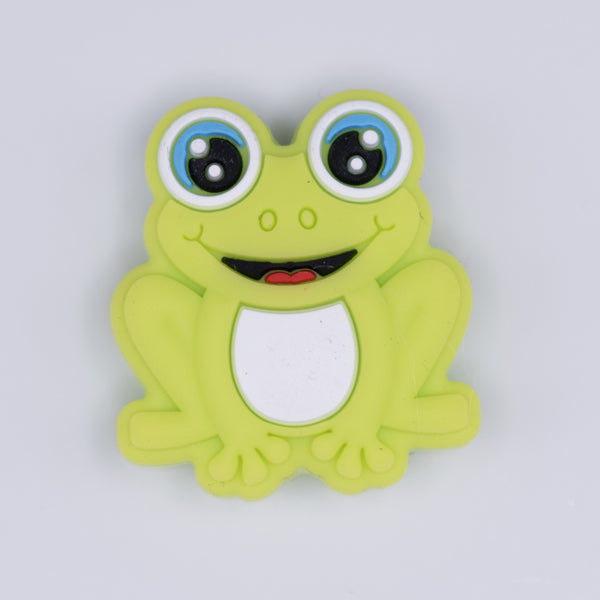 top view of a pile of Green Frog Silicone Focal Bead Accessory