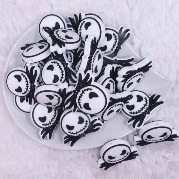 top view of a pile of Jack Face Silicone Focal Bead Accessory - 32mm x 29mm
