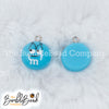 Top picture of a pile of Blue 16mm Candy M & M Resin charms