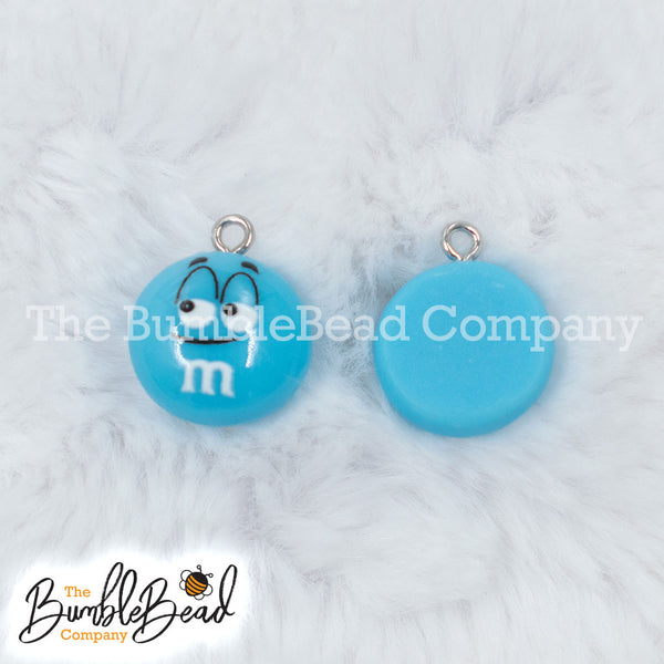 Top picture of a pile of Blue 16mm Candy M & M Resin charms