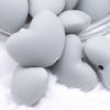 Close up view of a pile of 20mm Light Gray heart silicone bead