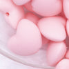 Close up view of a pile of 20mm Light Pink heart silicone bead