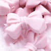Close up view of a pile of 27mm Light Pink Bow Knot silicone bead