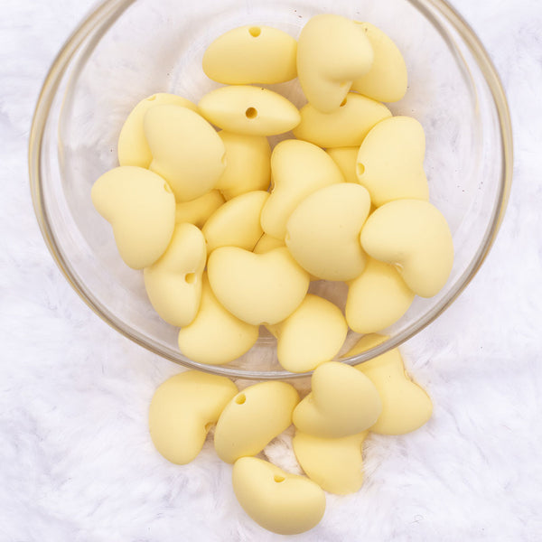 Top view of a pile of 20mm Light Yellow heart silicone bead
