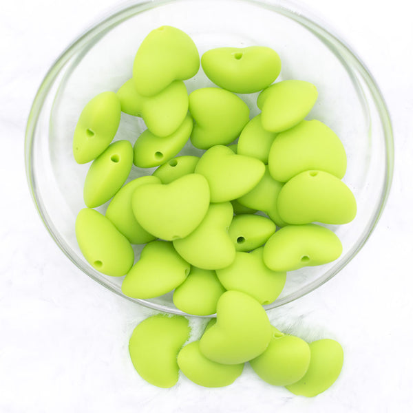 Top view of a pile of 20mm Lime Green heart silicone bead