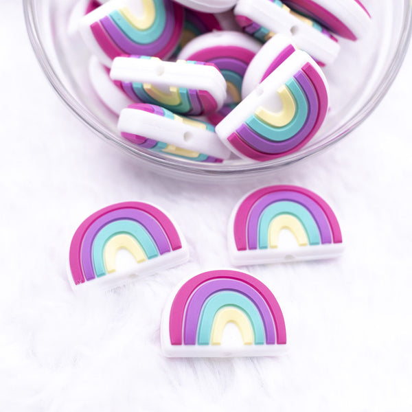 Top view of a pile of 25mm Bright Rainbow silicone focal bead