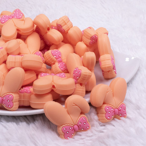 front view of Orange Bunny Ears Silicone Focal Bead Accessory - 26mm x 26mm