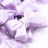 Close up view of a pile of 27mm Periwinkle Purple Bow Knot silicone bead