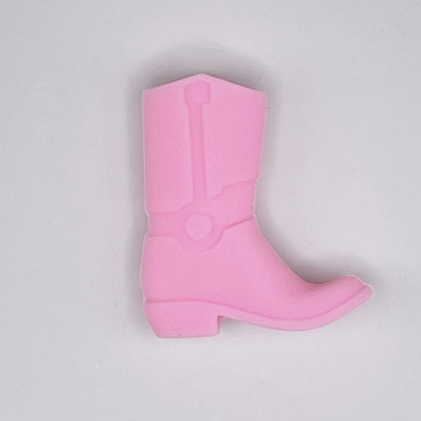 top view of a pile of Pink Cowboy Boot Silicone Focal Bead Accessory - 30mm x 26mm