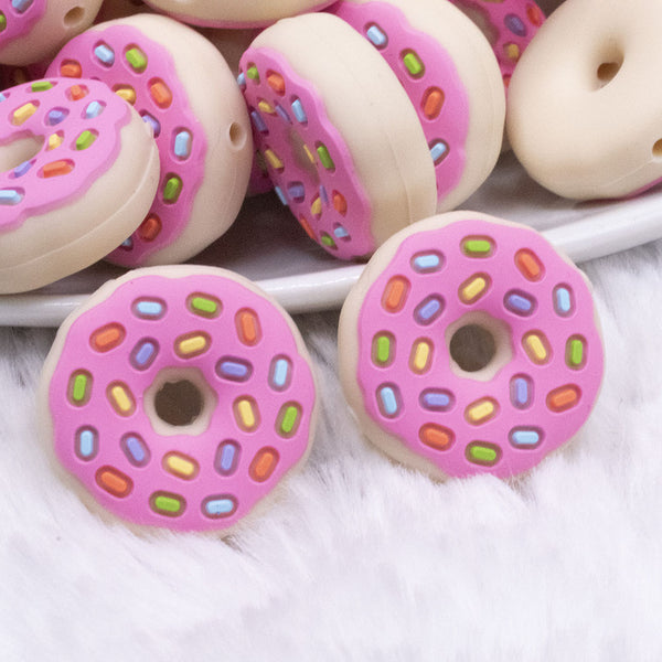 macro view of a pile of Donut with Pink Icing and Sprinkles Silicone Focal Bead Accessory - 28mm