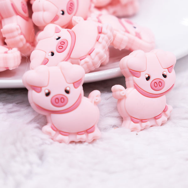 close up view of a pile of Pink Pig Silicone Focal Bead Accessory