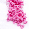 Front view of a pile of 27mm Pink Bow Knot silicone bead