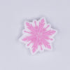 top view of a pile of Pink Snowflake Silicone Focal Bead Accessory - 28mm x 28mm