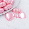Micro view of a pile of 27mm Pink Pearl Heart Acrylic Bubblegum Beads