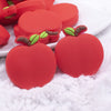 Close up view of a pile of Red Apple Silicone Focal Bead Accessory - 30mm x 27mm