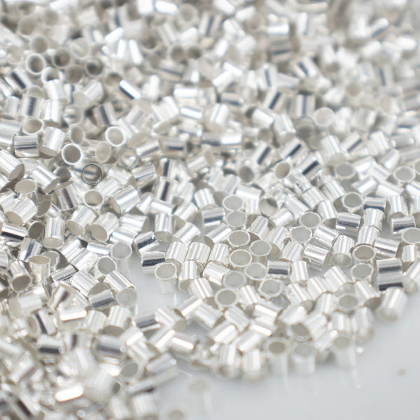 Top Close up view of a pile of 2mm Silver Crimp Tubes for Jewelry Making