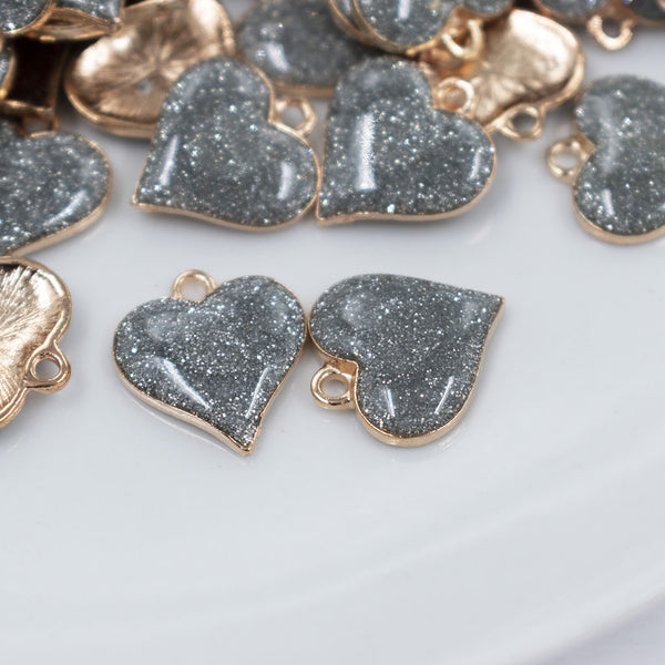 Front view of a pile of Silver Glitter Enamel Heart Charm 15mm