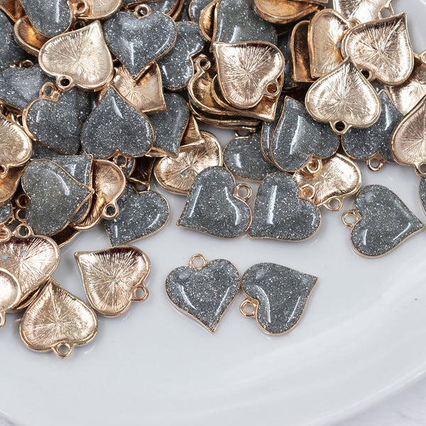 Top view of a pile of Silver Glitter Enamel Heart Charm 15mm