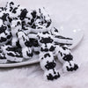 front view of a pile of Small Cow Silicone Focal Bead Accessory - 28mm x 20mm