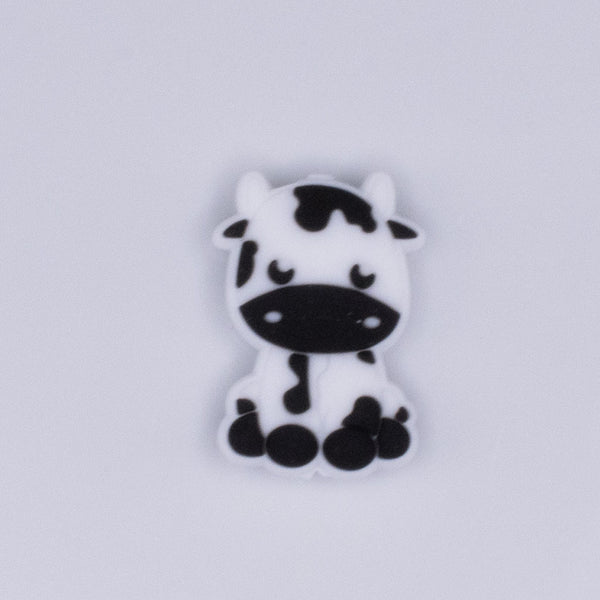 top view of a pile of Small Cow Silicone Focal Bead Accessory - 28mm x 20mm