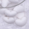 Close up view of a pile of 20mm White heart silicone bead