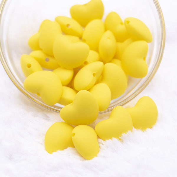 Top view of a pile of 20mm Yellow heart silicone bead