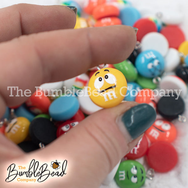 Close up picture of a pile of 16mm Candy M & M Resin charms