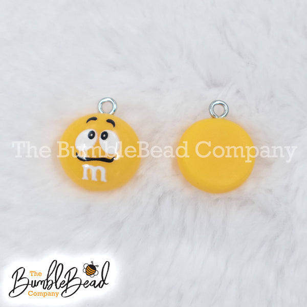 Top picture of a pile of Yellow 16mm Candy M & M Resin charms