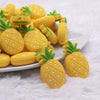 front view of a pile of Pineapple Silicone Focal Bead Accessory - 19mm x 32mm