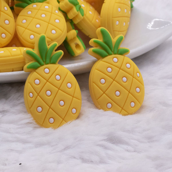 close up view of a pile of Pineapple Silicone Focal Bead Accessory - 19mm x 32mm